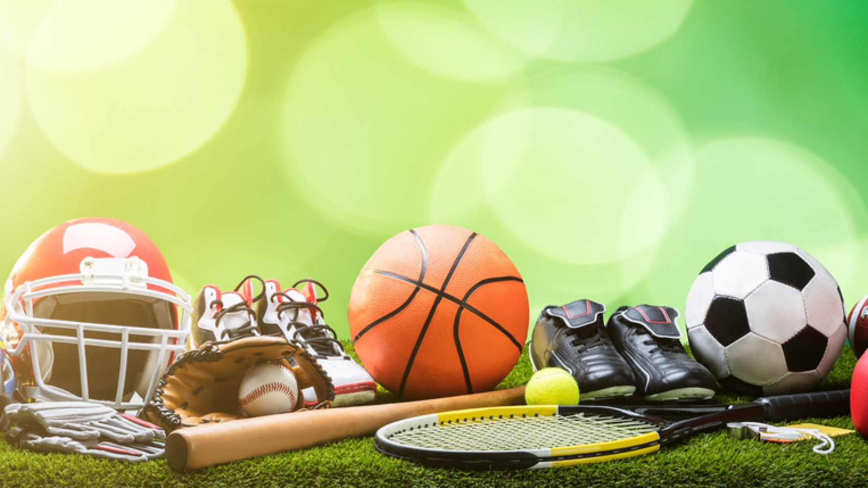 Close-up Of Various Sport Equipments On Pitch Against Bokeh Background